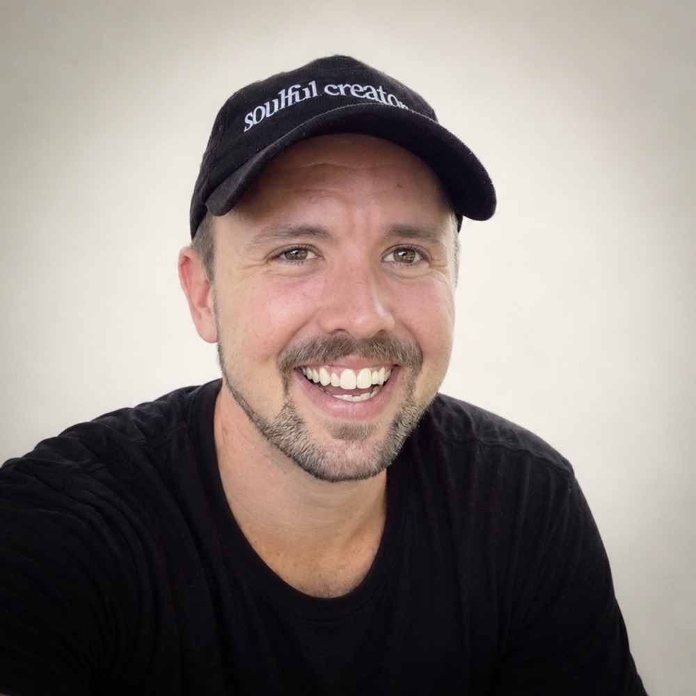 Chaz Bademan smiling in a black cap and black t-shirt
